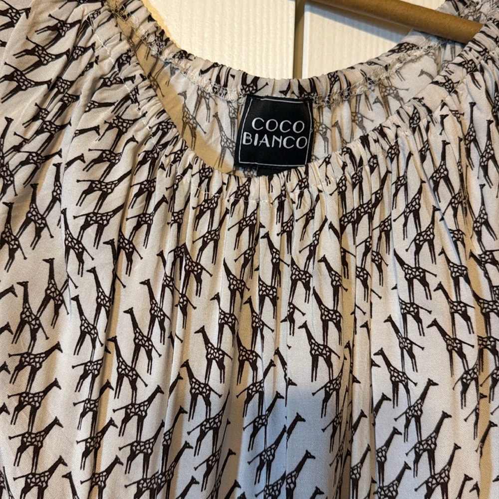 Giraffe print top. Adorable sleeves, tie front on side. Size L